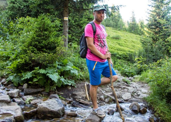 Young man hiking in the mountains