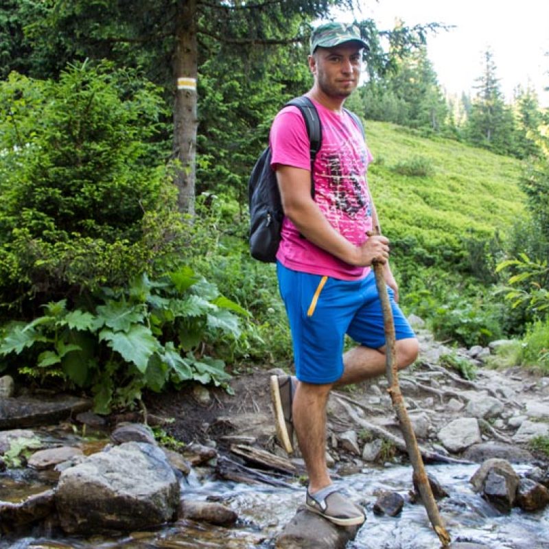 Young man hiking in the mountains